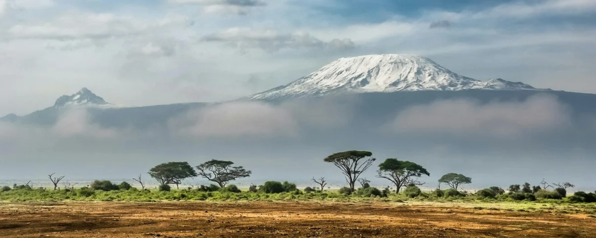 Snow-capped peak beyond the acacia plains of the Kenyan highlands